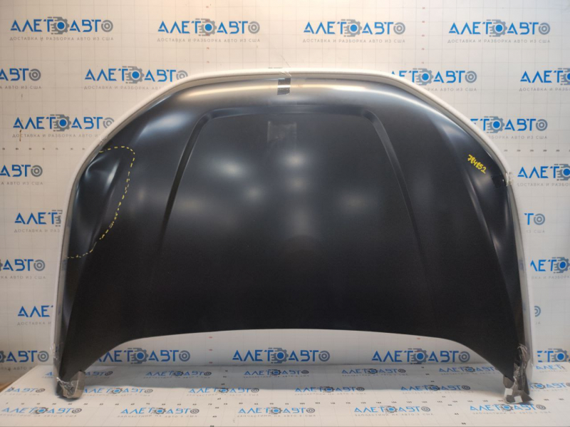 The hood of a Ford Edge 19-24 aluminum is bare and has a large dent.