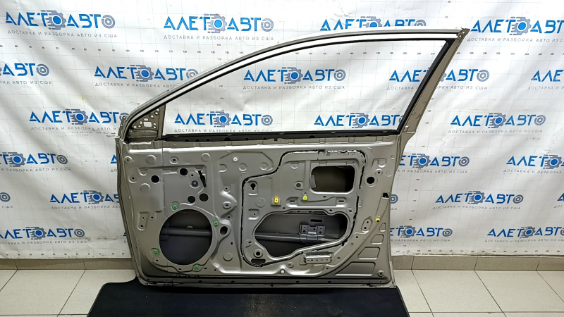 The front right door of a Toyota Avalon 13-18 beige 5B2 is bare and dented.