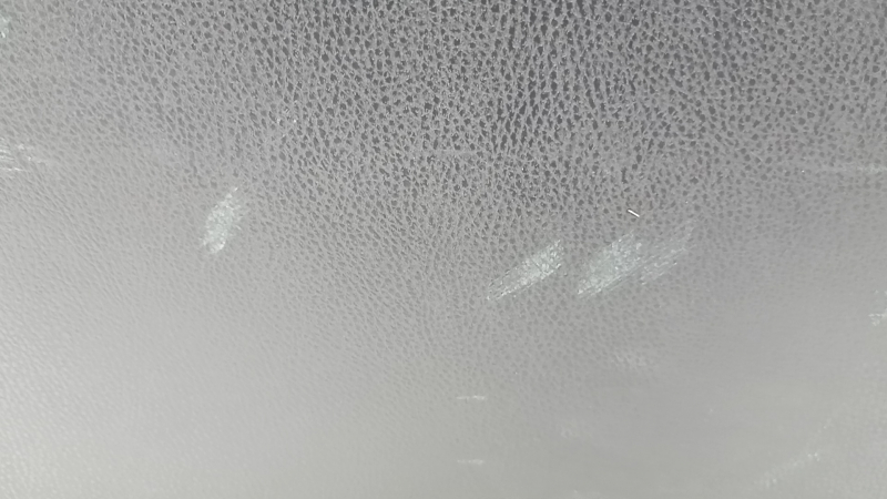 The trunk door trim of a 19-2019 Toyota Highlander is black, with plugs, scratches, and broken fasteners.