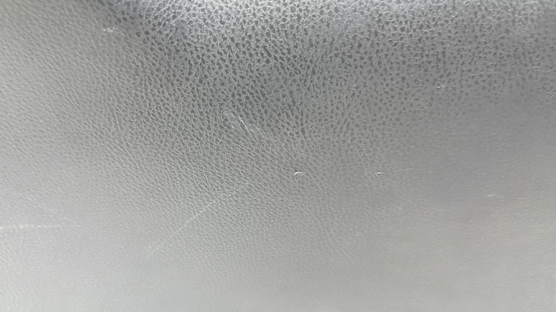 The trunk door trim of a 19-2019 Toyota Highlander is black, with plugs, scratches, and broken fasteners.