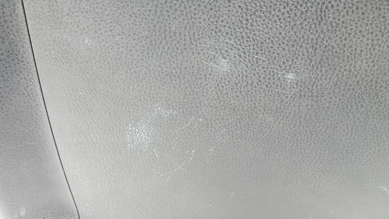 The trunk door trim of a 19-2019 Toyota Highlander is black, with plugs, scratches, and broken fasteners.