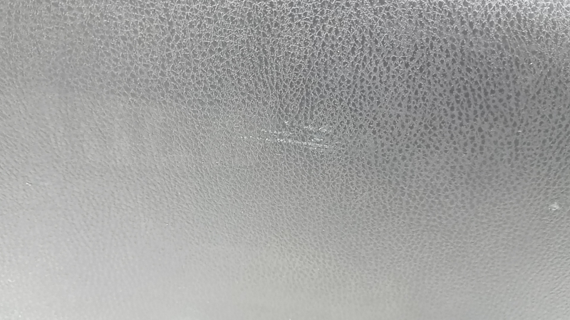 The trunk door trim of a 19-2019 Toyota Highlander is black, with plugs, scratches, and broken fasteners.