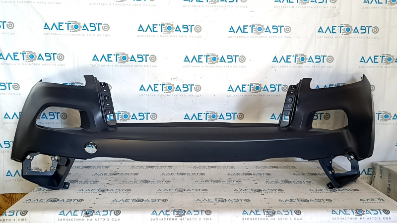 The front bumper is bare, the upper part of the Jeep Cherokee KL 14-14 without parking sensors, under the towing hook plug, dented