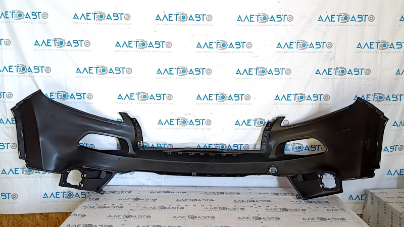 The front bumper is bare, the upper part of the Jeep Cherokee KL 14-14 without parking sensors, under the towing hook plug, dented