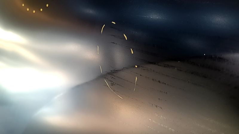 The rear left door of a Nissan Rogue 14-20 is bare and dented.