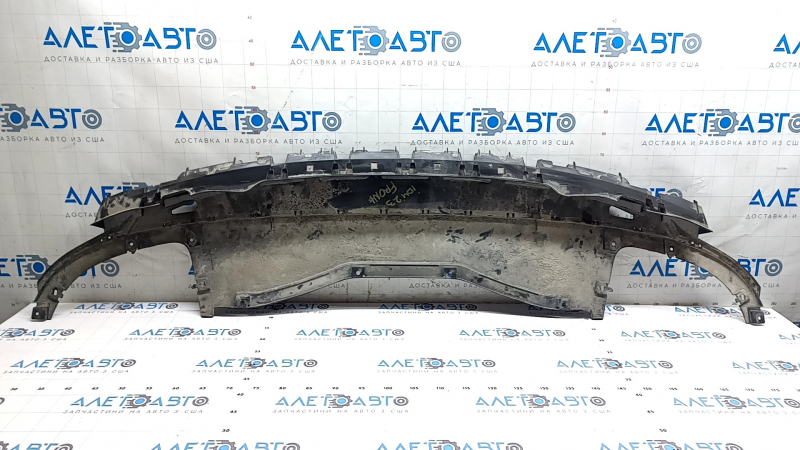 The front bumper center guard for Volkswagen ID.4 23-25 is worn and cracked.
