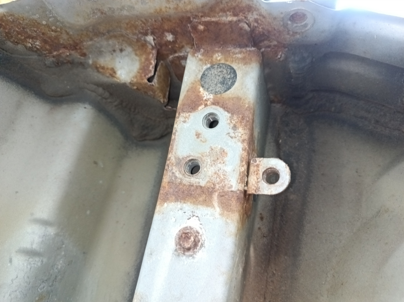 The rear panel of the Toyota Camry v40 is drilled, silver, rusty