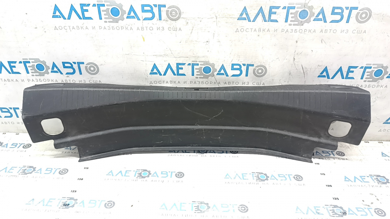 The trunk opening trim of the Cadillac CTS 14-19 is worn and scratched.