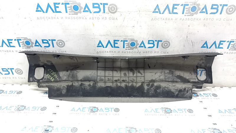 The trunk opening trim of the Cadillac CTS 14-19 is worn and scratched.