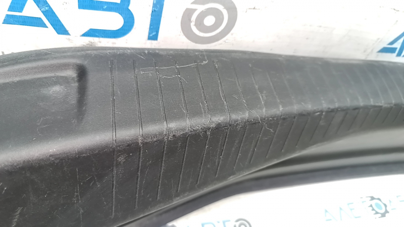 The trunk opening trim of the Cadillac CTS 14-19 is worn and scratched.