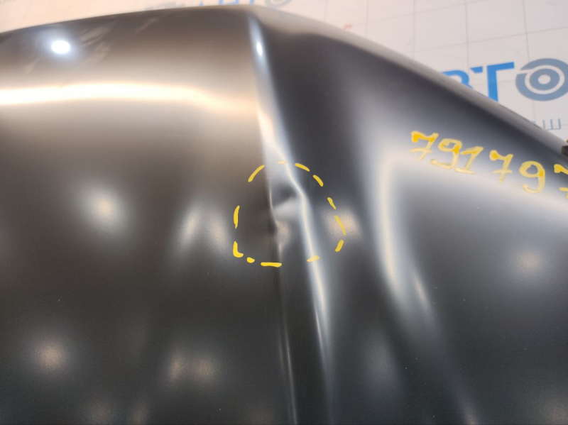 The hood of a Ford Fusion mk5 13-20 aluminum is bare, with dents on the edges.