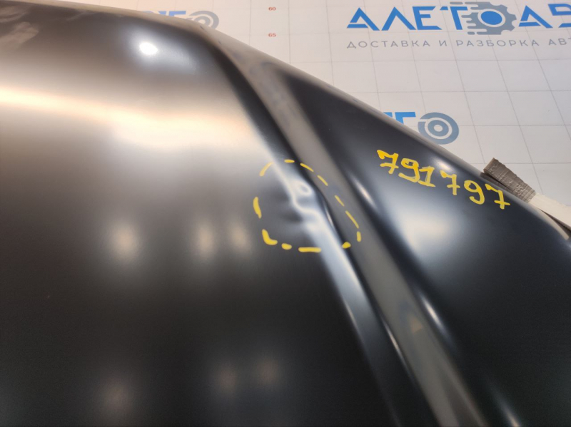 The hood of a Ford Fusion mk5 13-20 aluminum is bare, with dents on the edges.