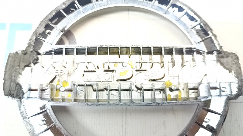The Nissan logo emblem on the tailgate of a Nissan Leaf 18-22 has broken guides.