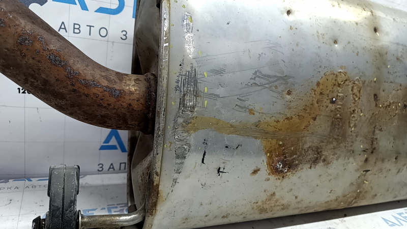 The exhaust pipe, the middle part with a catalytic converter, Hyundai Santa FE Sport 17-18 rest 2.4 is dented and rusty.