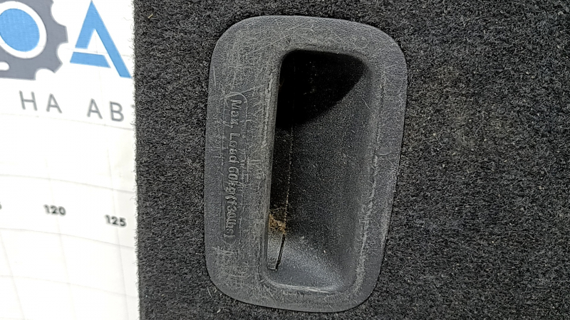 The trunk floor of a Kia Sportage 17-22 is black, with scratches on the handle.