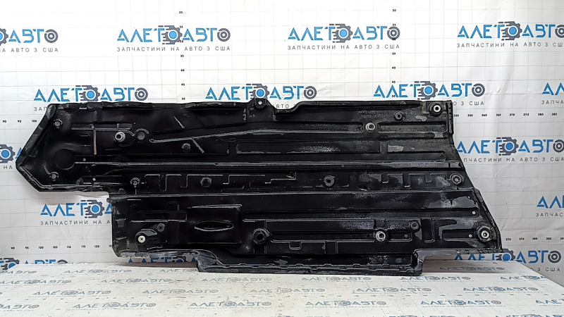 The left underbody protection of a Toyota Camry v70 18-24 is torn.