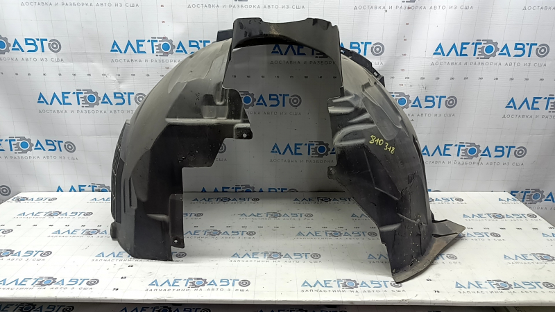 The front right fender liner of a Volvo XC90 16-23 is torn, non-factory holes