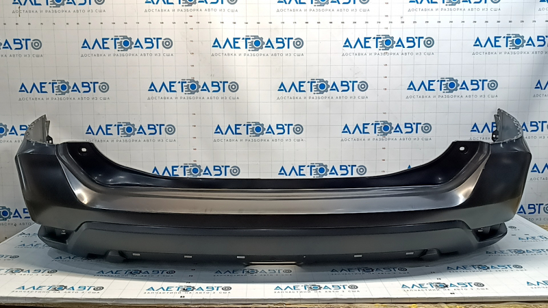 Bare rear bumper of a 17-20 Nissan Rogue without parking sensors, scratches
