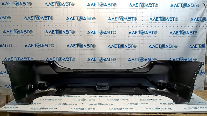 Bare rear bumper of a 17-20 Nissan Rogue without parking sensors, scratches