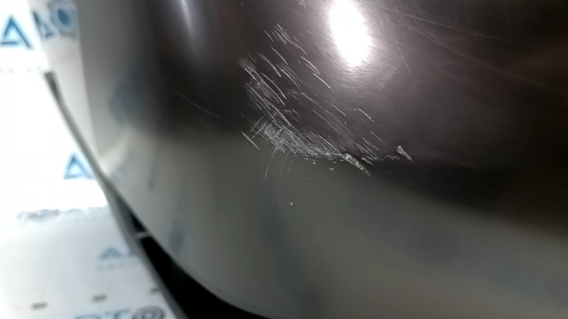 Bare rear bumper of a 17-20 Nissan Rogue without parking sensors, scratches