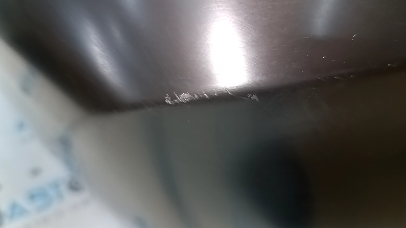 Bare rear bumper of a 17-20 Nissan Rogue without parking sensors, scratches