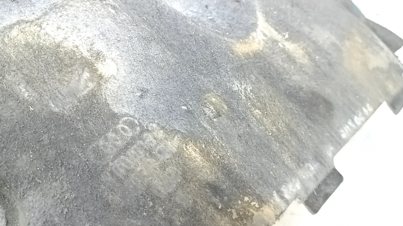 The front left underbody protection of the Audi A6 C7 12-18 is worn and dented.
