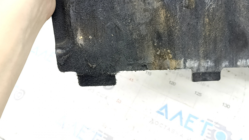 The front left underbody protection of the Audi A6 C7 12-18 is worn and dented.