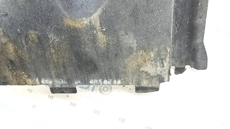 The front left underbody protection of the Audi A6 C7 12-18 is worn and dented.