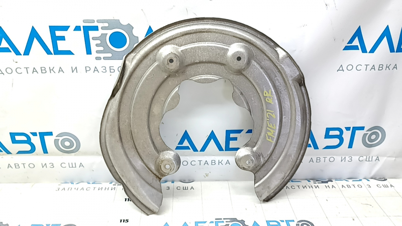 The rear right brake disc cover for a 2021-23 Ford Mustang Mach-E is dented.
