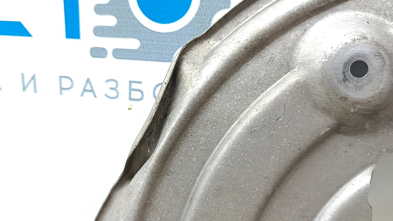 The rear right brake disc cover for a 2021-23 Ford Mustang Mach-E is dented.