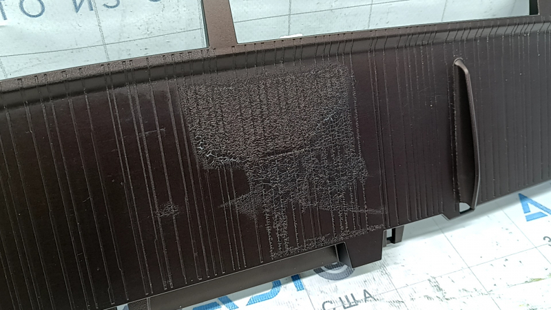 The lower front panel trim of a Toyota Sienna 21-24 is brown and the coating is swollen.