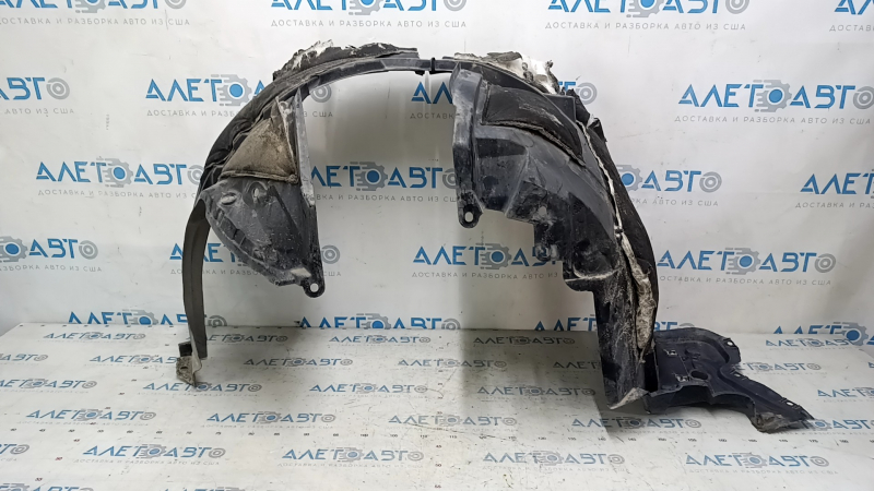 The front left fender liner of a Nissan Rogue 14-20 is broken and the sound insulation is torn.