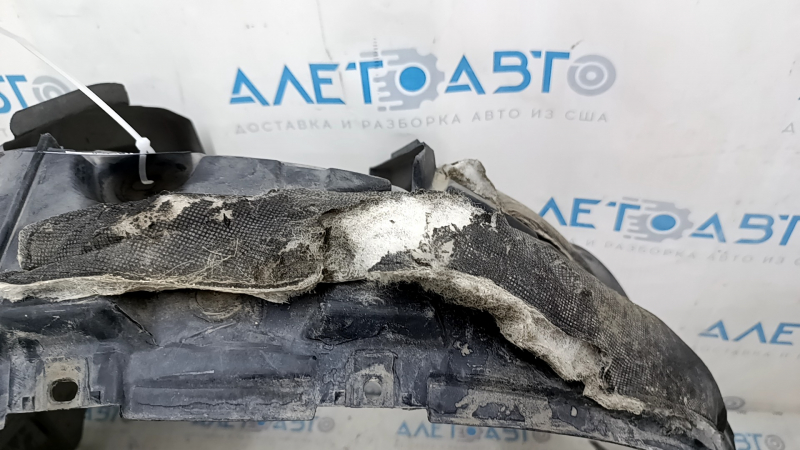 The front left fender liner of a Nissan Rogue 14-20 is broken and the sound insulation is torn.