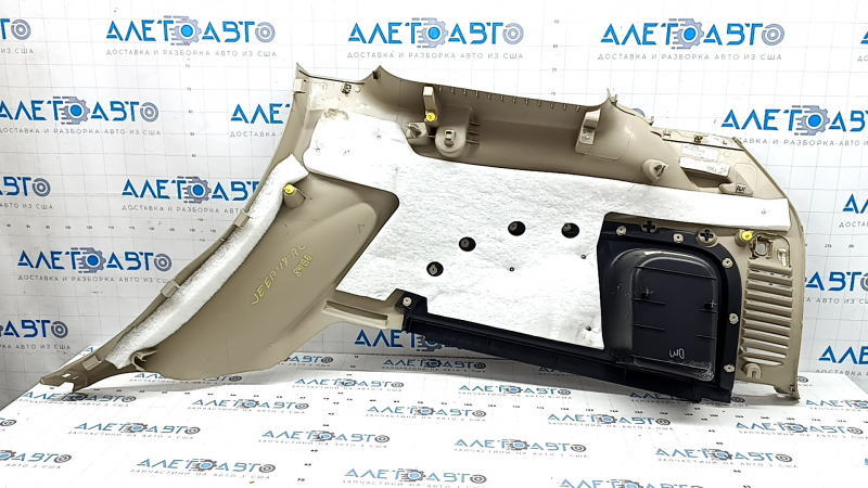 Left arch trim for a Jeep Grand Cherokee WK2 18-20, beige, electric, with hooks, scratches, crack, needs cleaning