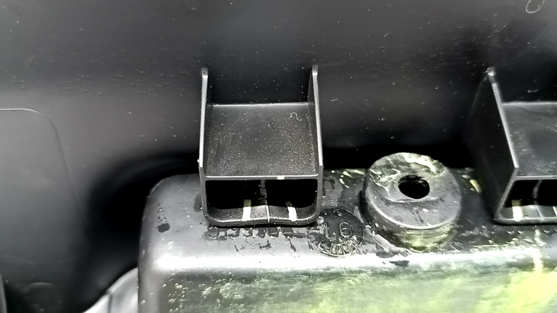 Jeep Renegade 15-23 black tailgate trim with scratches, cracks in fasteners, and abrasions