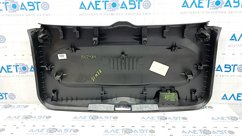Jeep Renegade 15-23 black tailgate trim with scratches, cracks in fasteners, and abrasions