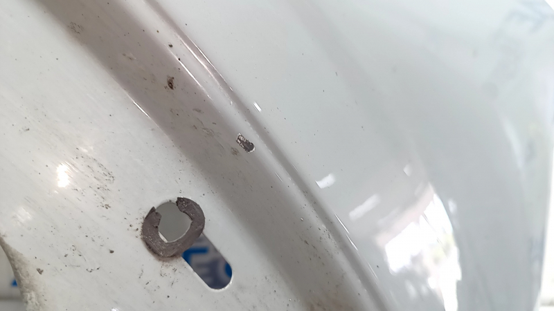 Front right fender of a 2015 Ford Bronco Sport, gray NE, chip, scratch