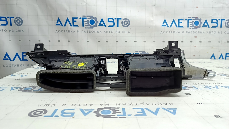 The central air vent for the front panel of the Audi A6 C7 16-18 is black, with a chrome trim, bumps on the chrome, scratches