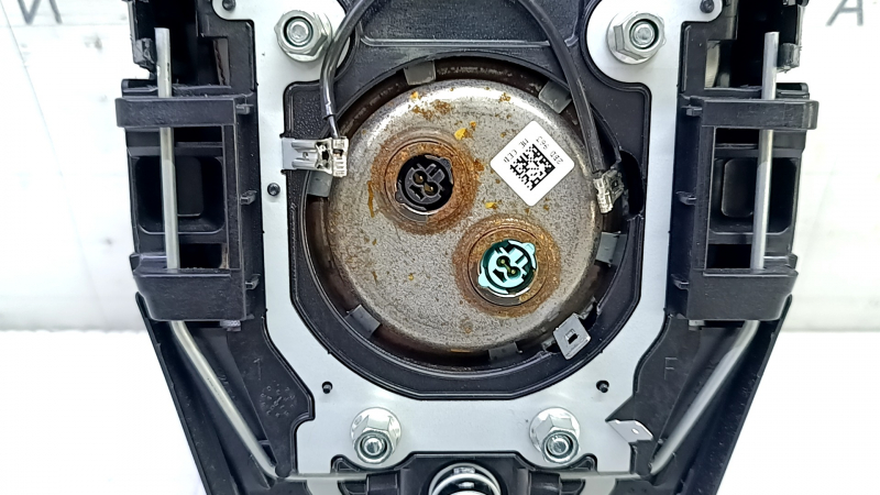 The driver's steering wheel airbag for a Toyota Prius 50 16-22 is black and has a rusty squib.