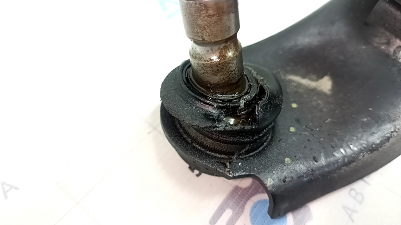 The front right lower control arm of a Mazda 3 19-23 Mexico-built model has a torn boot.