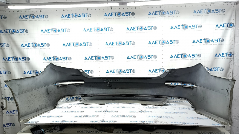 The rear bumper is bare, Honda Accord 18-22, red, with broken fasteners and filed down.