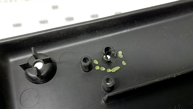 The front license plate plate of a Jaguar F-Pace X761 17-20 Sport is dented and the fasteners are broken.