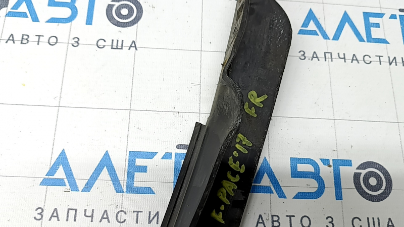 The right front bumper mudguard of a Jaguar F-Pace X761 17-20 is dented and worn.