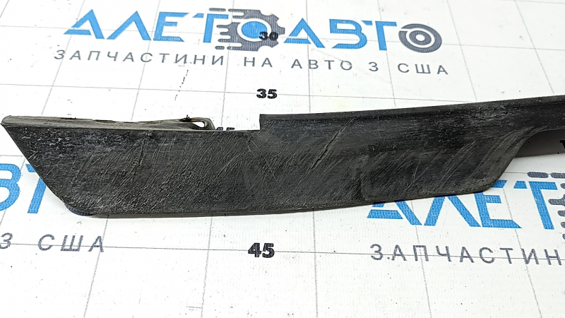 The right front bumper mudguard of a Jaguar F-Pace X761 17-20 is dented and worn.