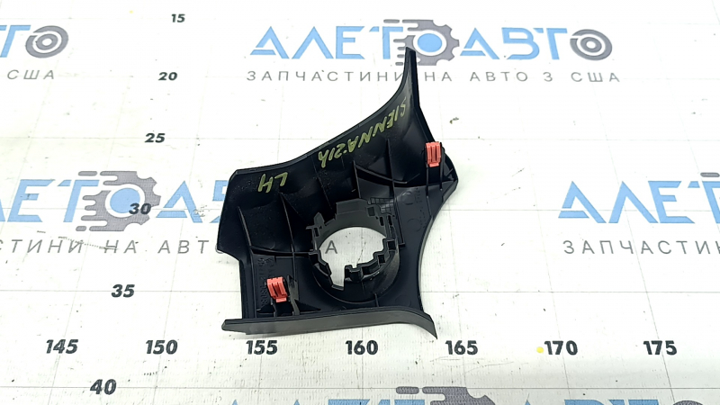 The front panel trim under the start/stop button for the Toyota Sienna 21-24 is black and scratched.