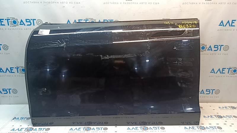 The front left door is bare, Tesla Model S 12-15 pre-restored, black PBSB, paint is peeling, scratches