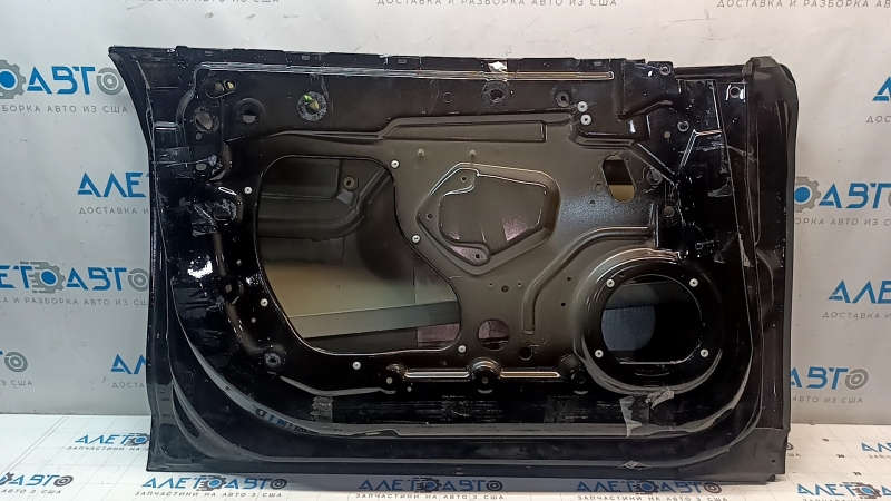 The front left door is bare, Tesla Model S 12-15 pre-restored, black PBSB, paint is peeling, scratches
