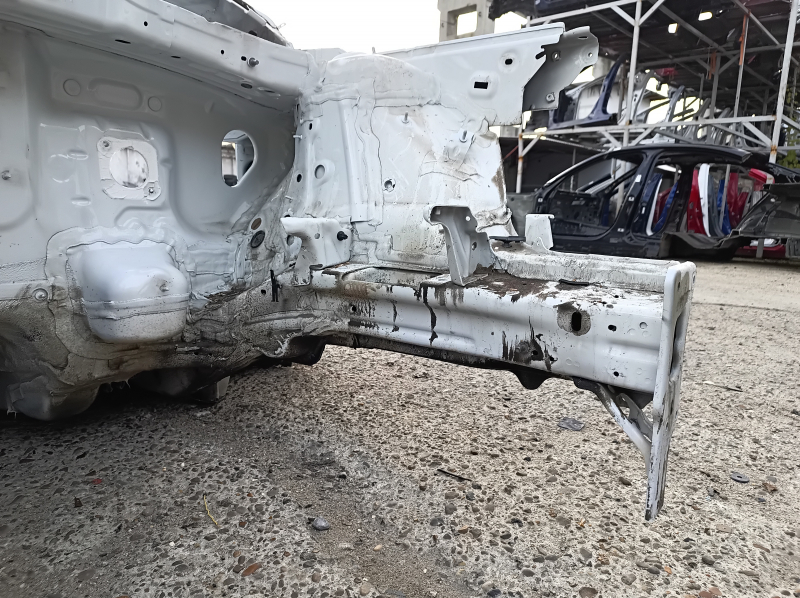 Front left quarter panel of a VW Atlas 18-25, white, dented pillar