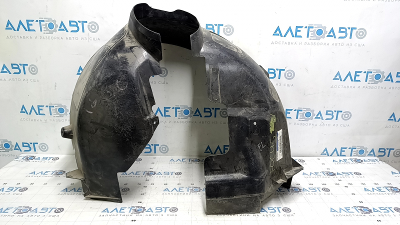 The front left fender liner of a Ford Focus mk3 11-18 is torn, missing a fragment