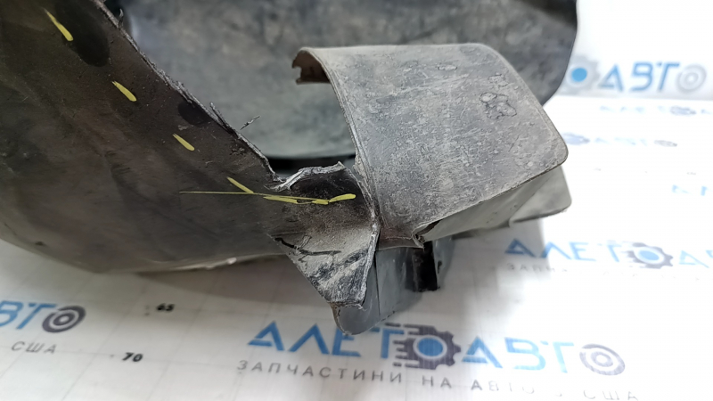 The front left fender liner of a Ford Focus mk3 11-18 is torn, missing a fragment